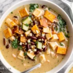 Discover the ultimate Creamy Chicken Taco Soup recipe! Packed with flavors, this easy-to-make soup combines tender chicken, beans, and a creamy broth for a cozy meal. Ready in 35 minutes!