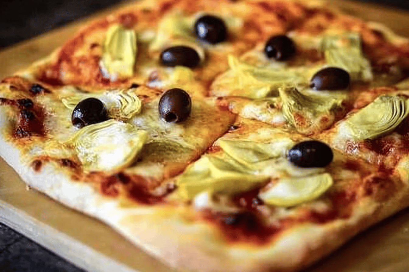 Dive into the rich flavors of artichokes and olives on a warm, cheesy pizza! 🍕✨