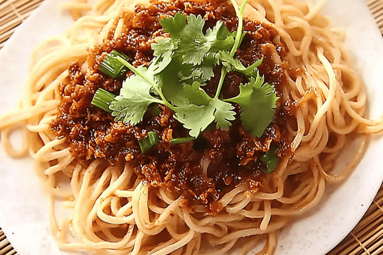 Deliciously spicy and nutty, these vegan Dan Dan noodles will wow your taste buds! 🌱🍜