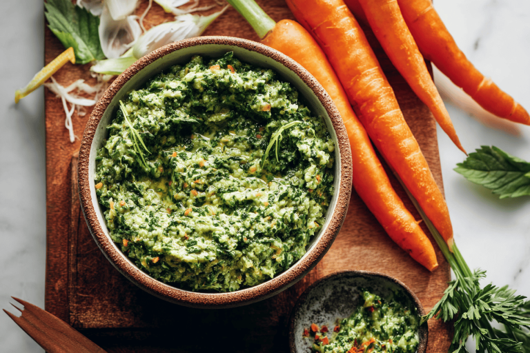 Discover a flavorful twist on pesto using carrot tops and spinach! Perfect for your next meal. 🌱🧄