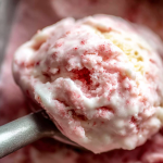 Bowl of homemade frozen yogurt topped with fresh strawberries and bananas.