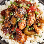 Delicious Sweet Hawaiian Crockpot Chicken served with rice and garnished with fresh green onions and sesame seeds.
