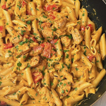 Creamy Cajun Chicken Pasta in a skillet, garnished with green onions, highlighting the delicious sauce and pasta.