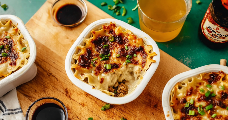Close-up of TikTok Dumpling Lasagna showcasing layers of dumplings, sauce, and garnishes.