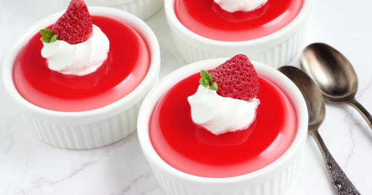 Delicious Greek yogurt jello cups garnished with raspberries and mint, perfect for a low-calorie dessert.
