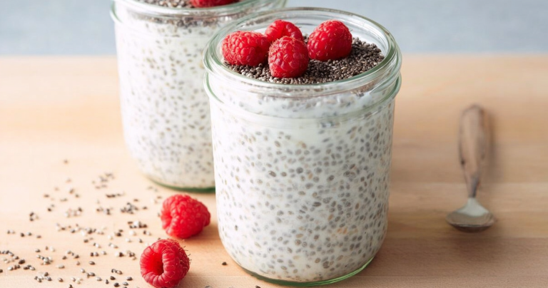 Yogurt chia pudding topped with strawberries and honey in a glass jar.