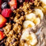 Healthy yogurt bowl with fresh fruits and granola on a wooden table