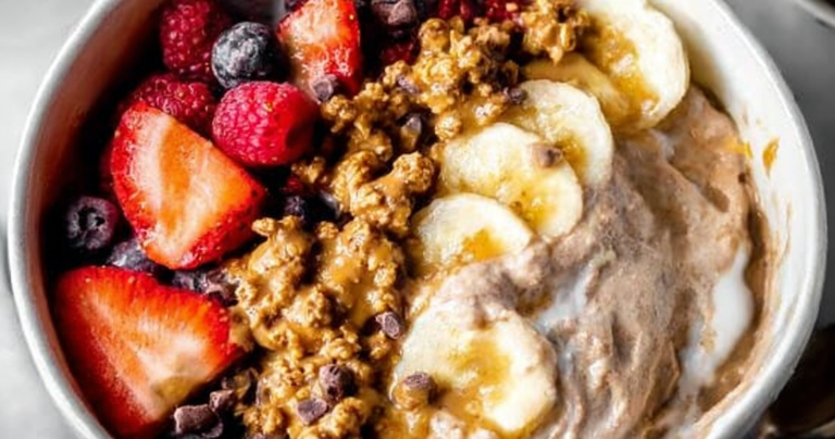 Healthy yogurt bowl with fresh fruits and granola on a wooden table