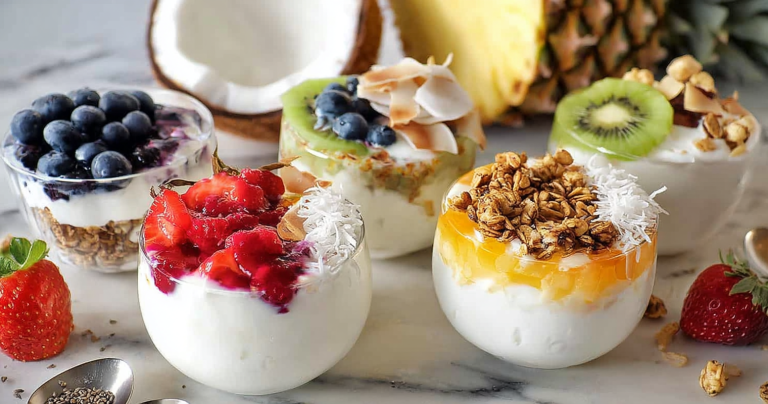 Greek yogurt breakfast bowl with fresh berries and honey on wooden table
