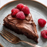 Sliced chocolate yogurt cake with fresh berries on a wooden board