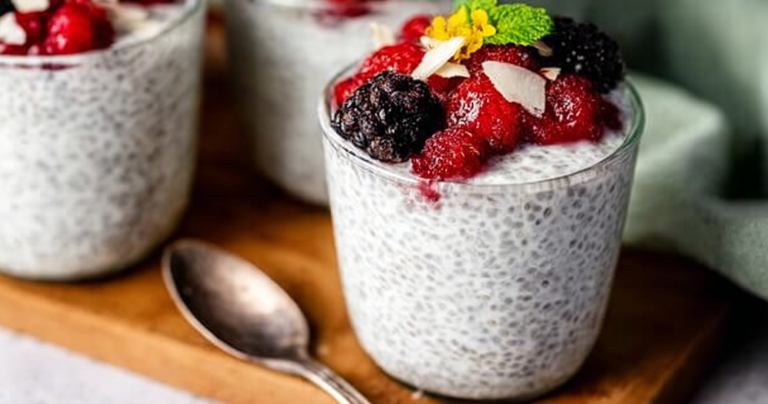 Delicious yogurt chia pudding topped with fresh berries and nuts in a rustic bowl.