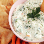 Healthy yogurt dip for veggies served with fresh colorful vegetables.