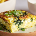A delicious cottage cheese egg bake with spinach and Parmesan cheese, served in a rustic dish.