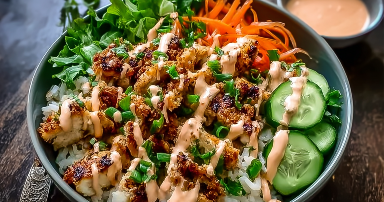 Bang Bang Chicken Bowl with avocado, cilantro, and sesame seeds over rice and vegetables