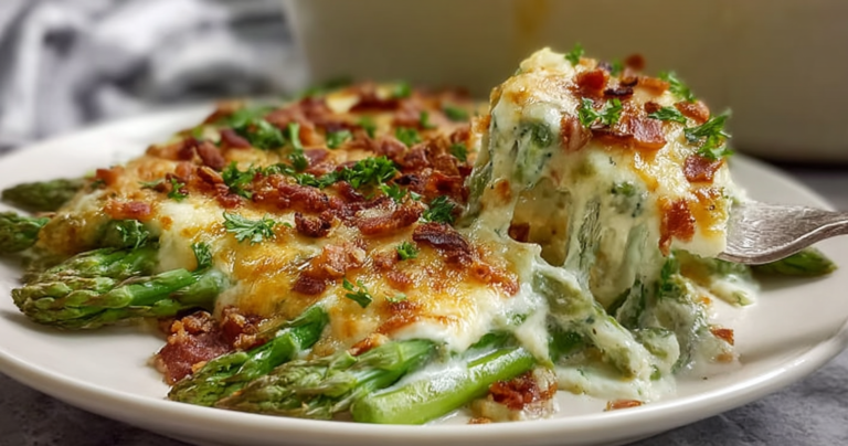 Deliciously baked keto asparagus casserole with melted cheese and crispy bacon served in a rustic dish.