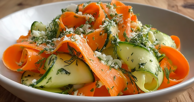 Close-up of a colorful Carrot and Cucumber Ribbon Salad with fresh herbs and lemon slices
