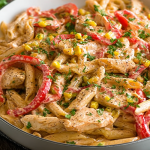 Delicious Cajun Chicken Pasta in a bowl topped with parsley and colorful bell peppers