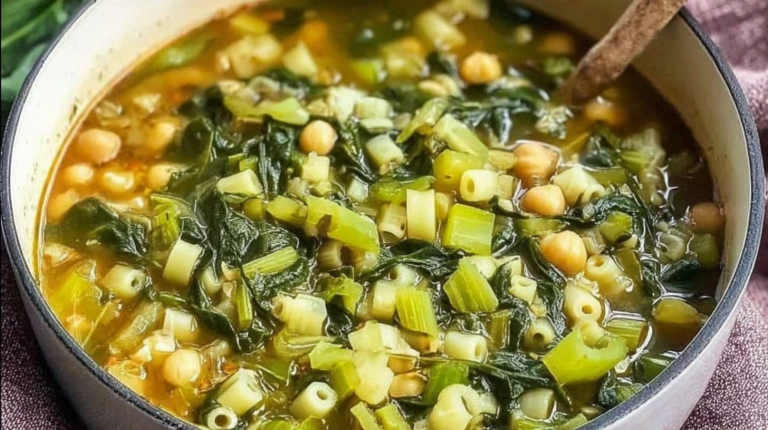 A bowl of vibrant spring minestrone soup with fresh vegetables, garnished with herbs.