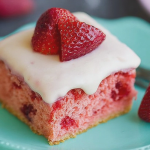 Sliced healthy strawberry cake on a wooden table, garnished with fresh strawberries.