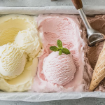 Homemade no churn ice cream with chocolate chips and strawberries served in a bowl.
