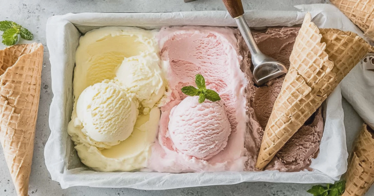 Homemade no churn ice cream with chocolate chips and strawberries served in a bowl.
