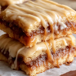 Delicious Salted Caramel Brown Sugar Pop Tart Cookie Bars with cinnamon glaze and sea salt, displayed on a wooden surface.