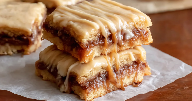 Delicious Salted Caramel Brown Sugar Pop Tart Cookie Bars with cinnamon glaze and sea salt, displayed on a wooden surface.