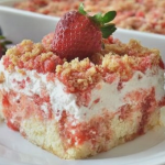Close-up of Strawberry Crunch Poke Cake with fresh strawberries garnishing the top, showcasing the colorful layers inside.