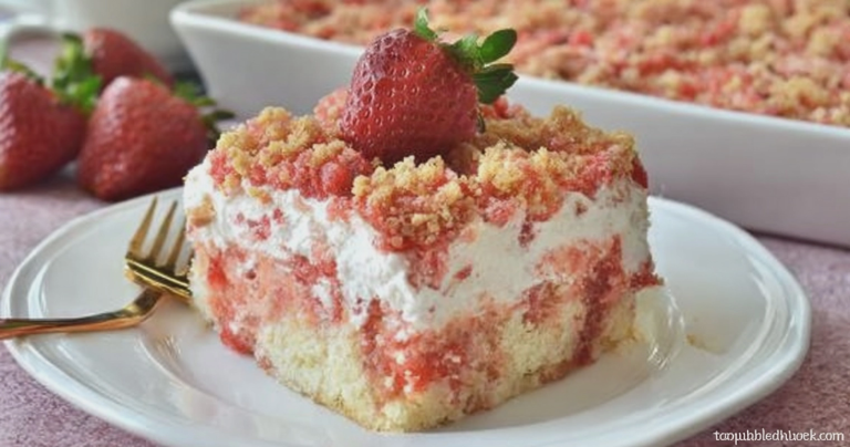 Close-up of Strawberry Crunch Poke Cake with fresh strawberries garnishing the top, showcasing the colorful layers inside.