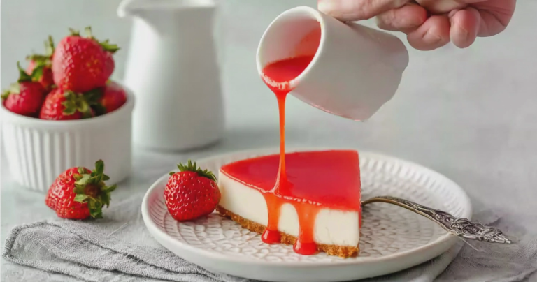 Fresh strawberry pie topped with strawberry glaze and garnished with mint leaves.