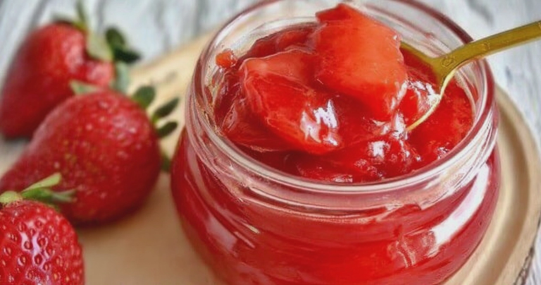 Sugar-free strawberry sauce on pancakes with fresh strawberries and mint garnish.